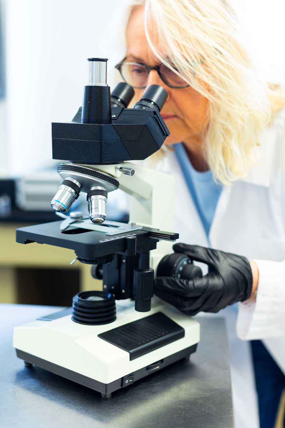 Microbiologist at microscope